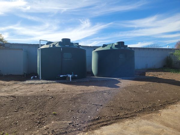 Completed Brancott Estate water tank pad with topsoil spread around base