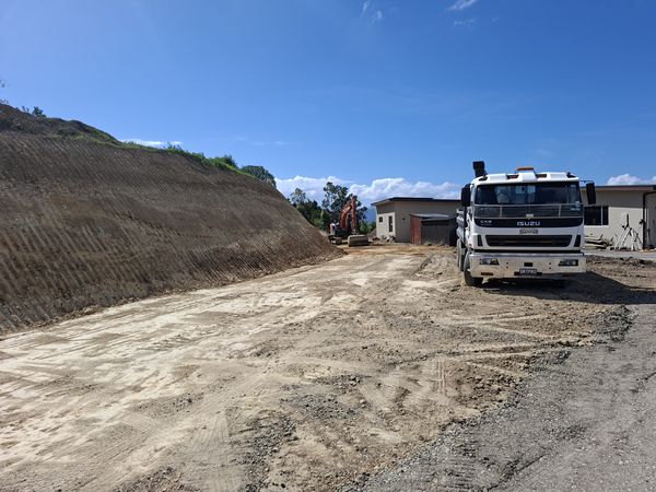Excavator moving earth during 3,000 cubic metre cut and fill project