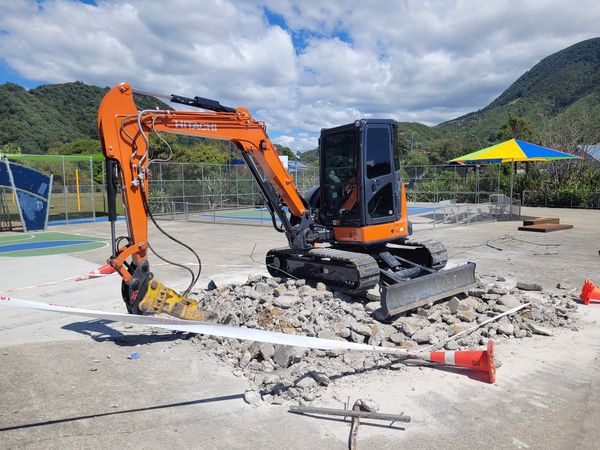 Breaking up old concrete skate park ramps in Picton, Marlborough